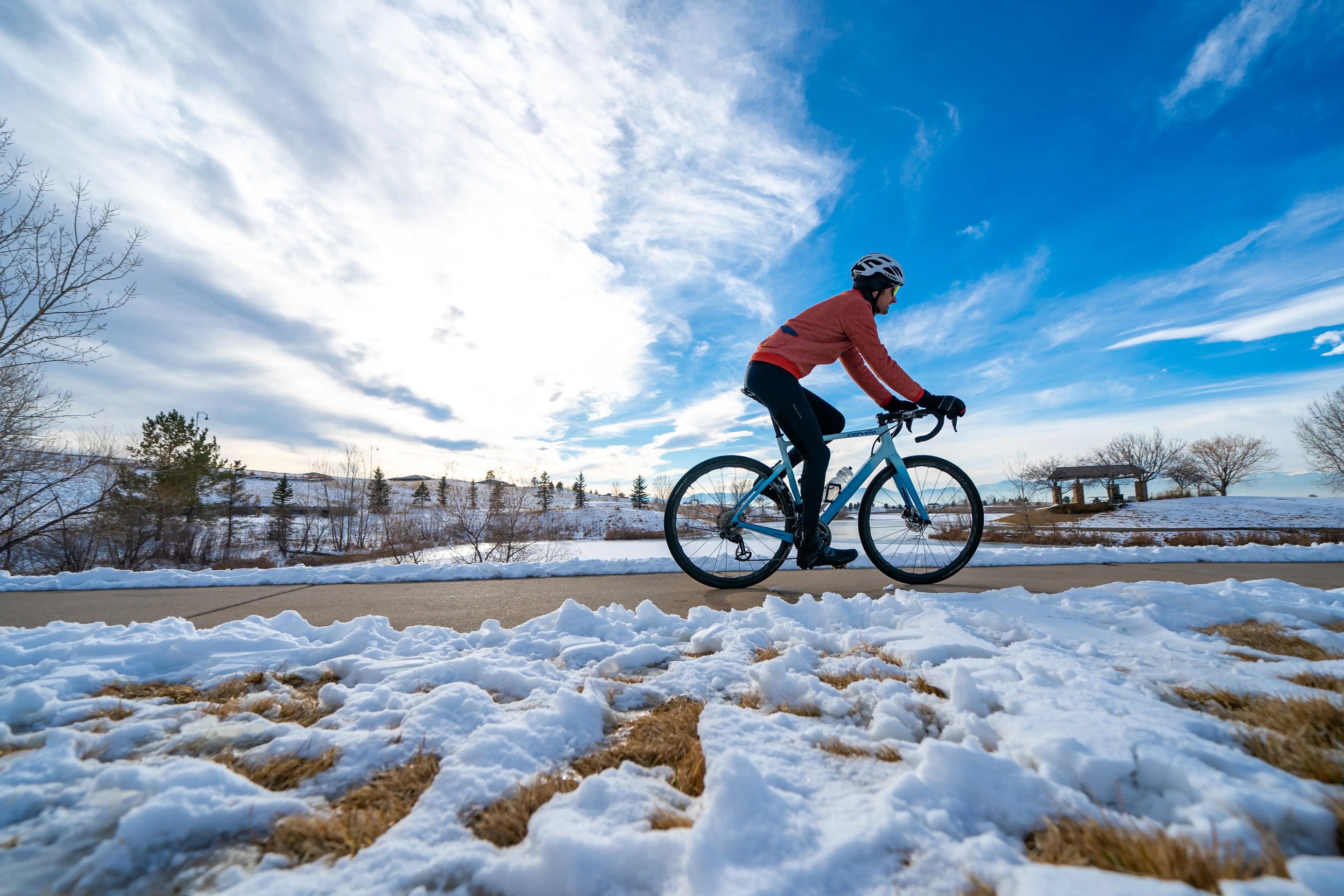 Cyclist riding on path on a snowy day